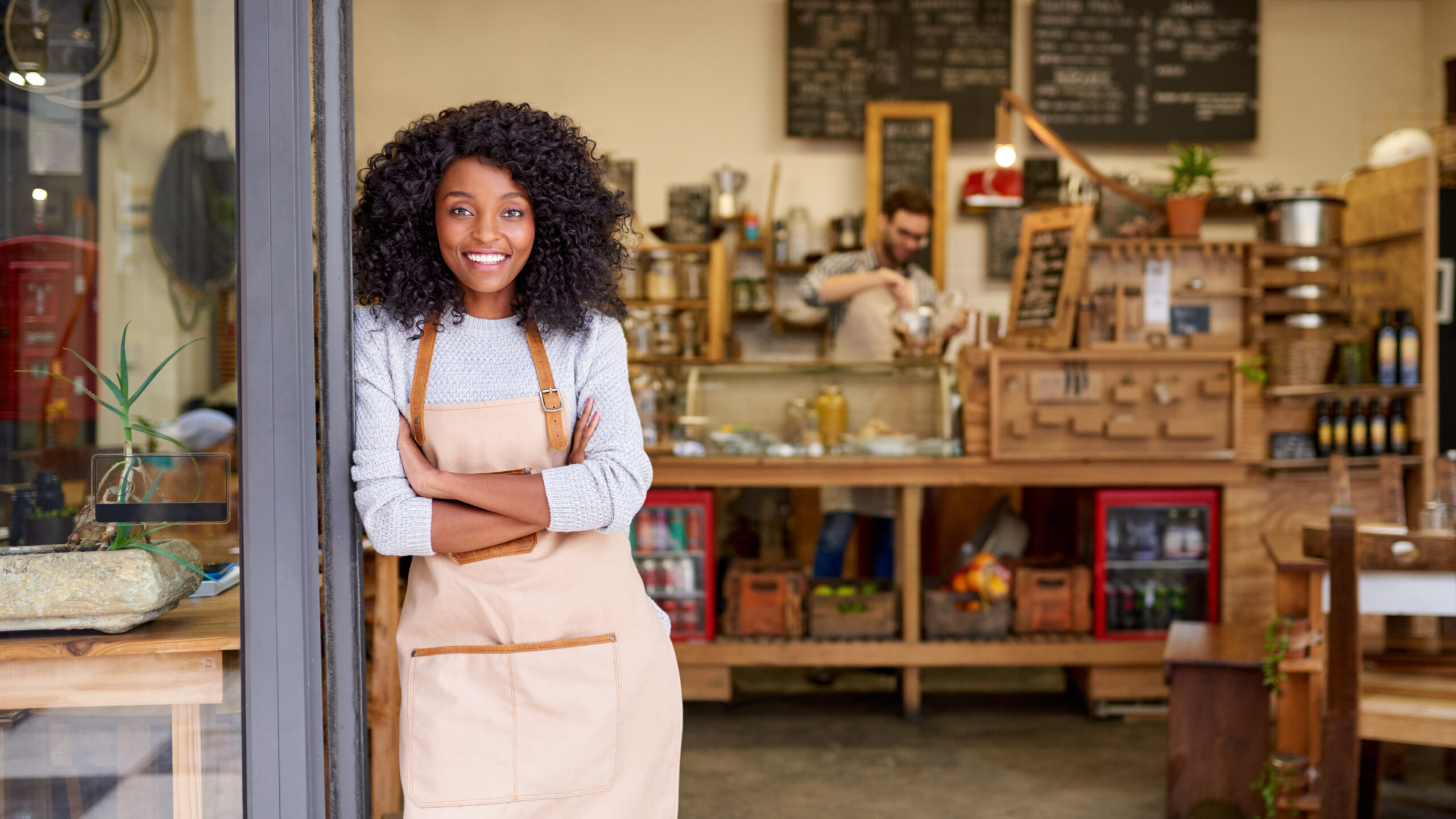 Woman standing in front of small business