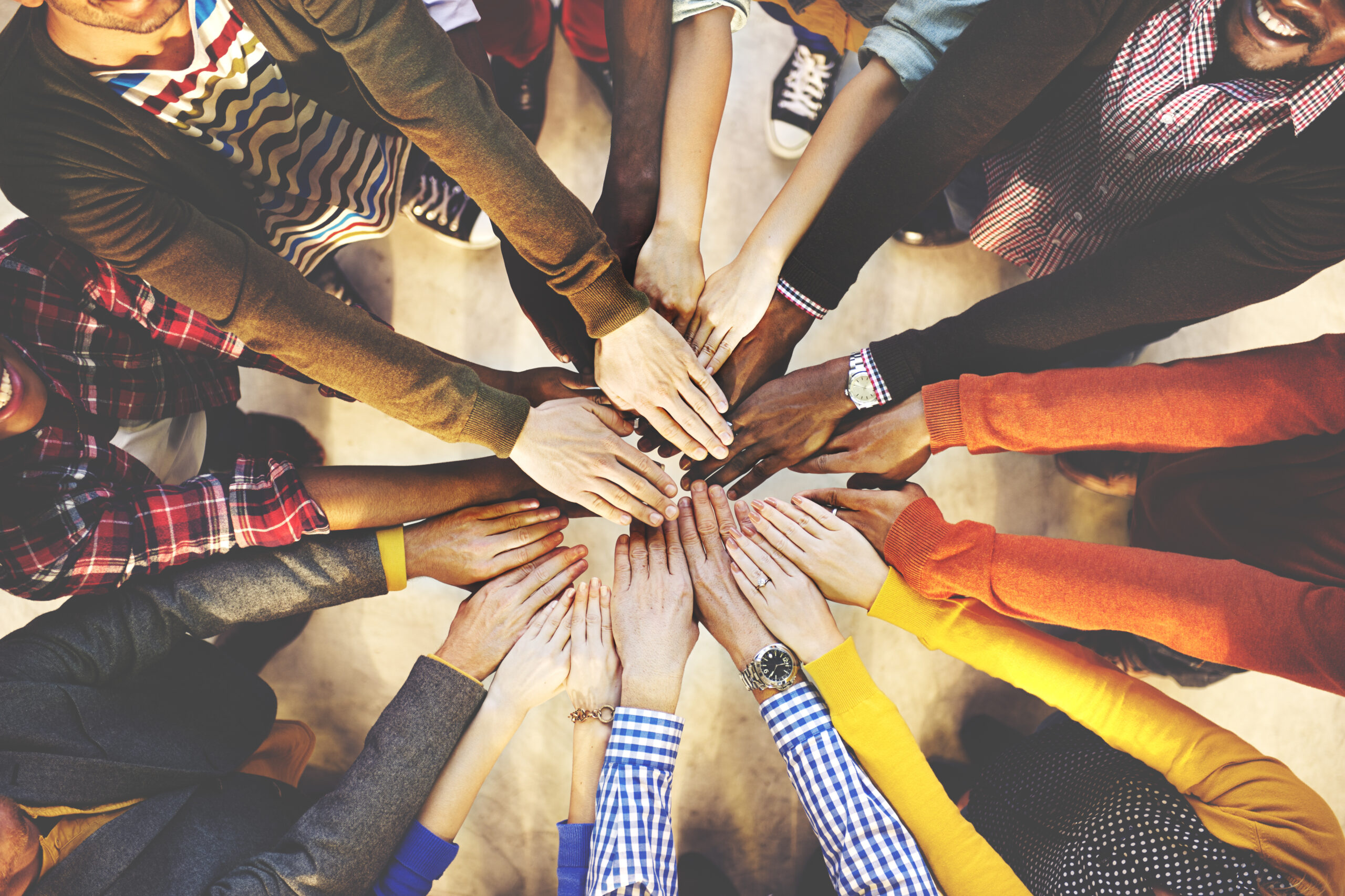 Group of people with hands together in a circle