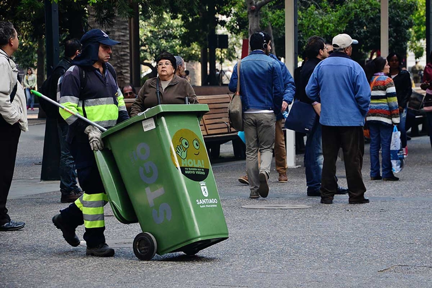 Worker collecting trash in park in Chile